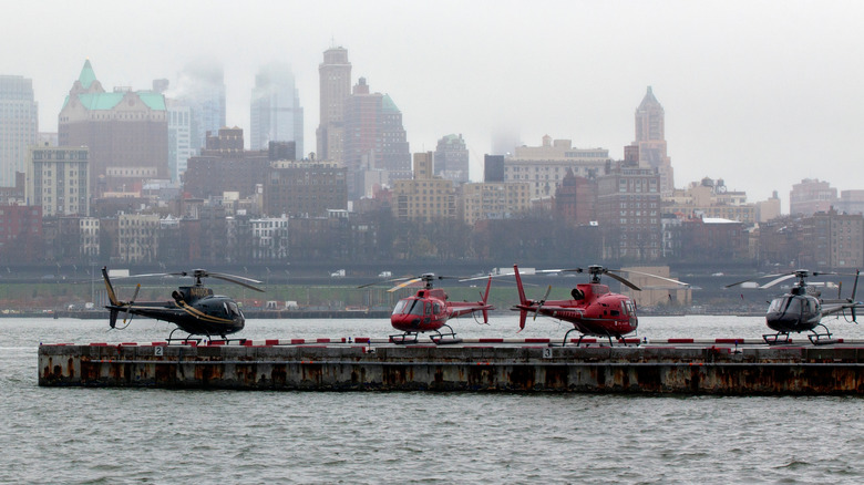 A lineup of helicopters at one of the New York City's heliports along the river.