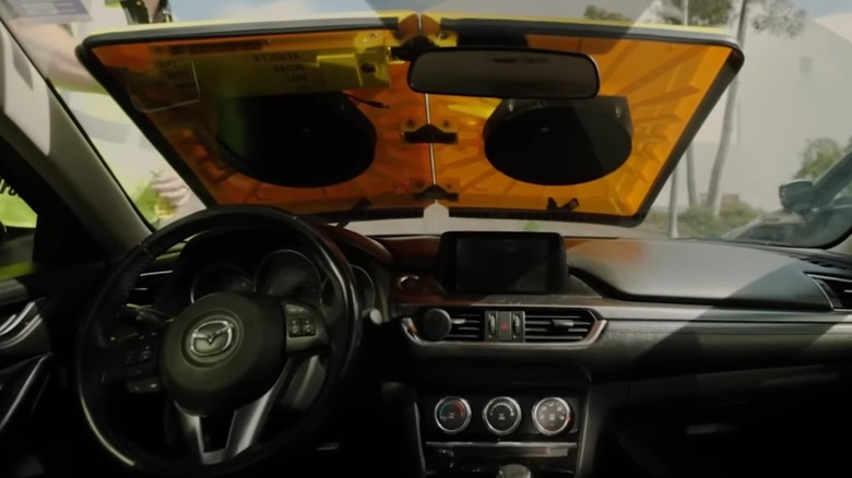A view from the interior of a Mazda 6 after an official attached a parking barnacle device