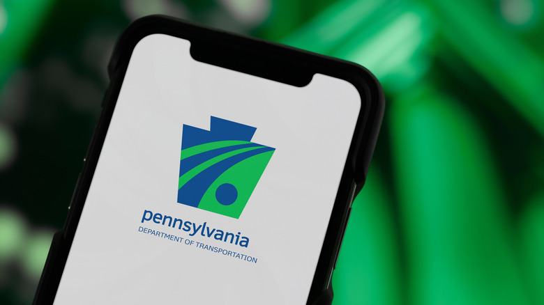 A smartphone open to the Pennsylvania Department of Transportation app
