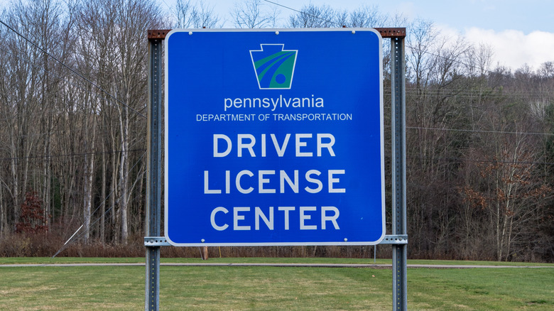 A large blue sign for a Pennsylvania Department of Transportation licensing center