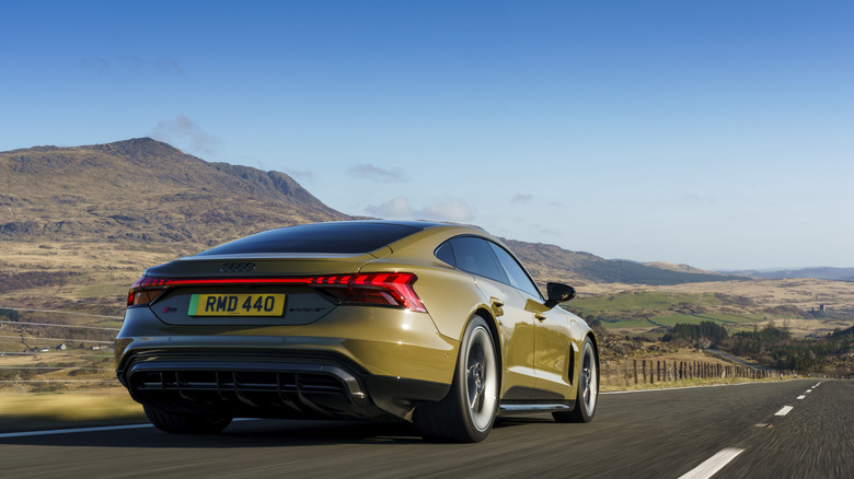 Rear shot of a khaki-green Audi RS e-tron GT driving
