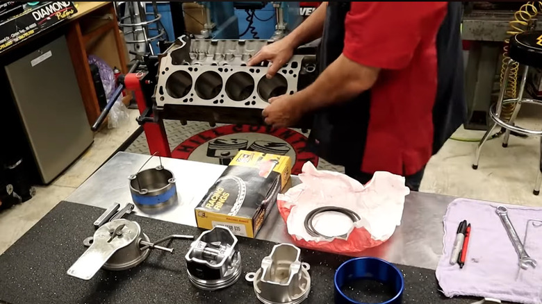 Tools used to check piston ring end gaps on a technician's table