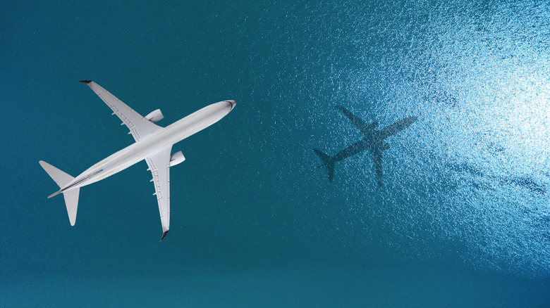 An artist's rendering of an overhead shot of an airliner over open ocean