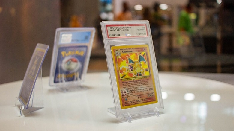 A First Gen Charizard Pokemon card cased and on display on a table at the 2021 New York Comic Con.