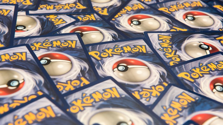 A flat pile of Pokemon trading cards, just the backs with the pokeball.