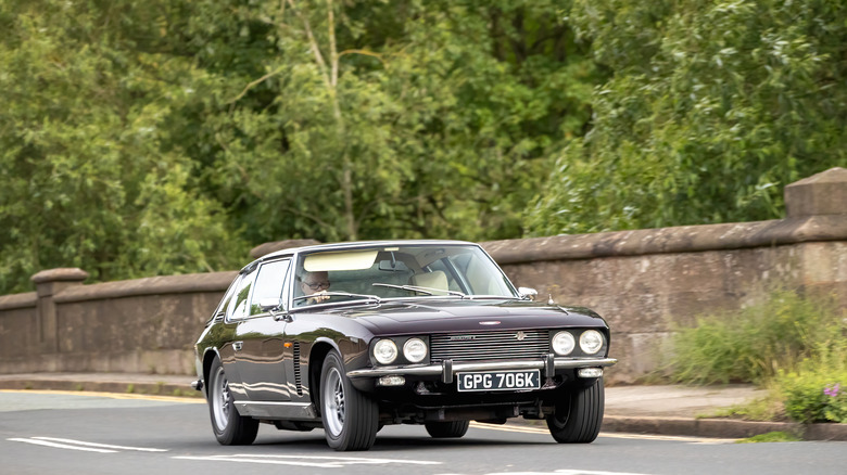 Jensen Interceptor being driven down a lane