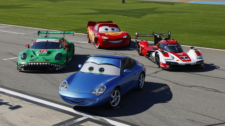 Lightning McQueen and Sally Carrera from "Cars" with Porsche race cars