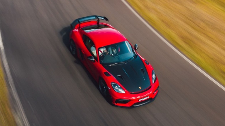 Overhead view of a red Porsche 718 Cayman GT4 RS in motion.