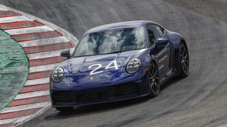 A blue Porsche 911 Carrera S driving down the Corkscrew at Laguna Seca