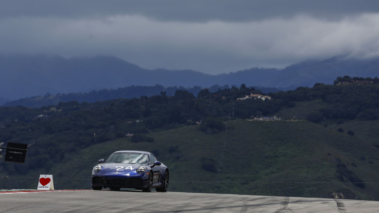 A blue Porsche 911 Carrera S on track at Laguna Seca