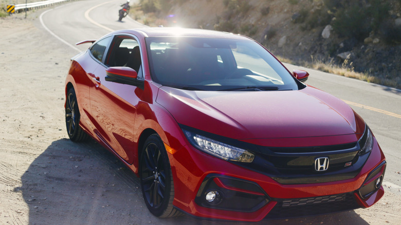 A 10th-generation 2020 Honda Civic Si bathed in sunny SoCal light on a mountain road.