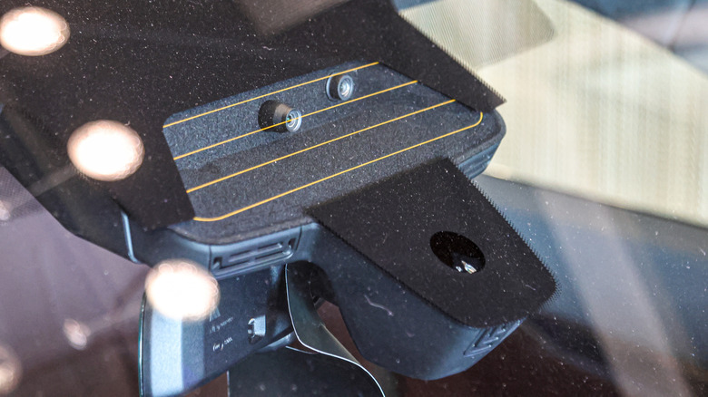 A dashcam module with LiDAR technology inside a car