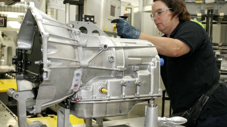 Automatic transmission being assembled in a factory.