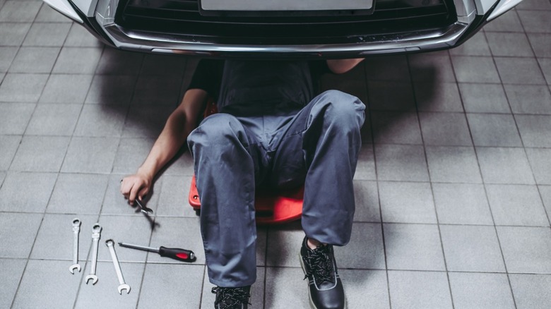 man working under car