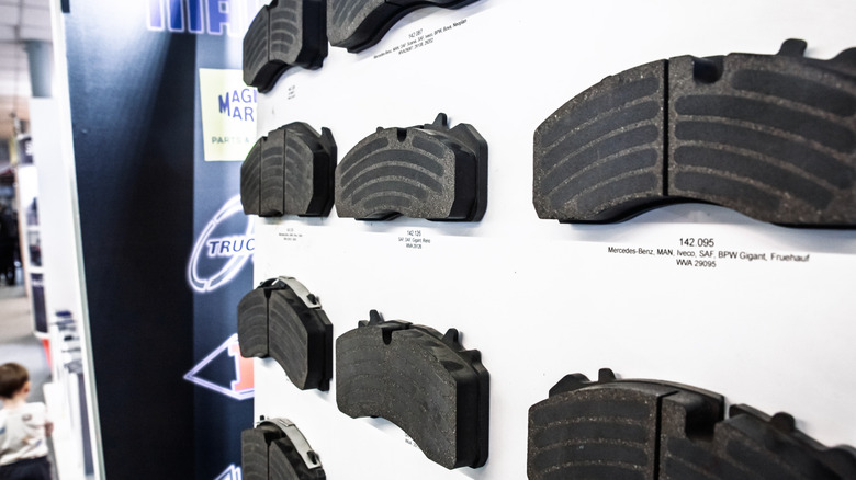 Wall mounted matrix of commercial vehicle and car brake pads at an auto-parts store in Belgrade, each reference labelled for MAN, Mercedes-Benz, SAF and other brands