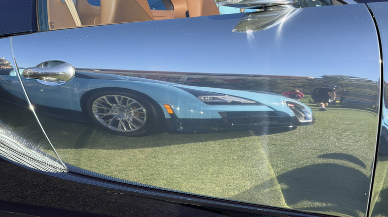 Polished aluminum doorway sheet connected a Bugatti Veyron showing nan reflection of different Veyron