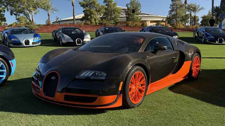 Front 3/4 position of a achromatic c and orangish Bugatti Veyron Super Sport