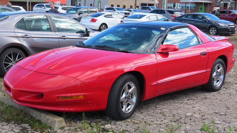 Red 1997 Pontiac Firebird coupe in parking lot
