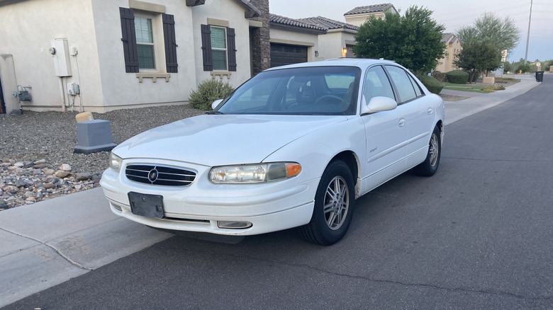 Front 3/4 of white Buick Regal in front of house