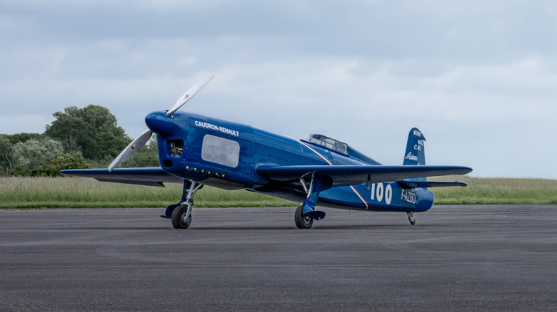 A restored Renault Caudron Rafale C.460 parked on a runway