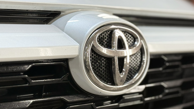 Moscow, Russia, JAN. 3, 2026: Close-up Toyota RAV4 V (XA50) logo, emblem. White Toyota RAV4 front side, hood, radiator grille. Japan SUV car Toyota Toyota RAV4 V (XA50) logo on radiator grille.
