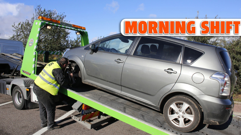 A car being loaded onto a flatbed