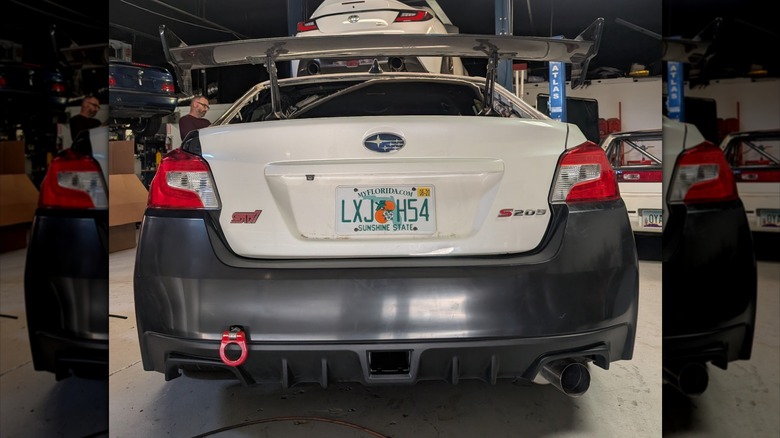 Rear view of Ryan Stewart's Subaru WRX STI S209 during its restoration with an unpainted bumper and missing rear window