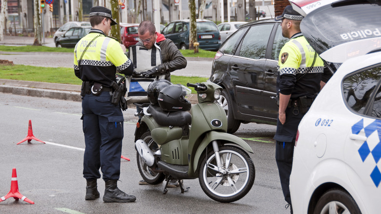 Police officers apprehending a motorcycle rider