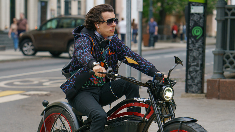 A motorcycle rider with earphones while driving