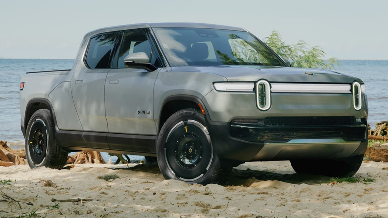 A gray Rivian R1T Truck parked on a beach