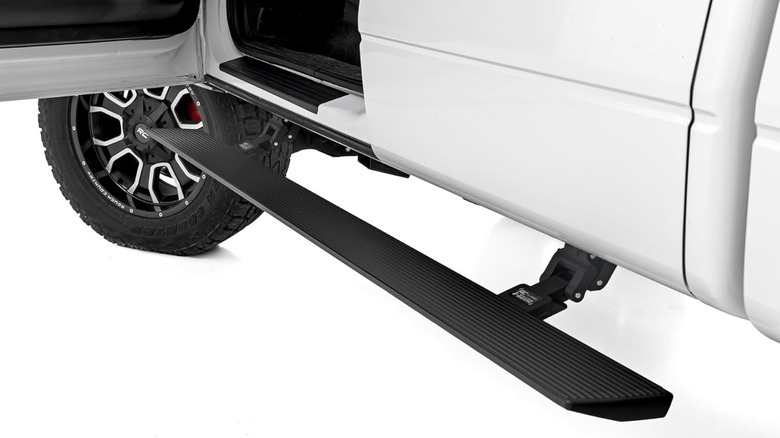 Power retractable running boards attached to a vehicle