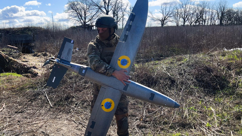 A Ukrainian soldier holds a long-range drone