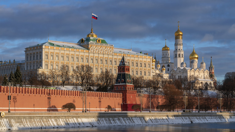 View of the building of the Grand Kremlin Palace, the Annunciation Tower and the ensemble of the Kremlin Cathedral Square from the embankment of the Moskva River, Moscow, Russia.
