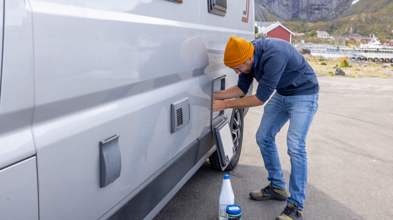 Man performing maintenance on an RV