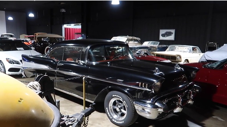 A section of the Sarasota Classic Car Museum centered on a black 1957 Chevy Bel Air