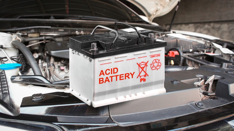 Car battery sitting on front of a car