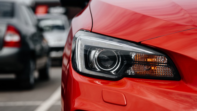 Close up of a red car's right-hand side headlight
