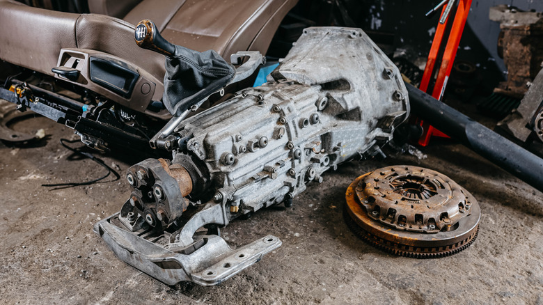 Transmission and other parts laying on a shop floor