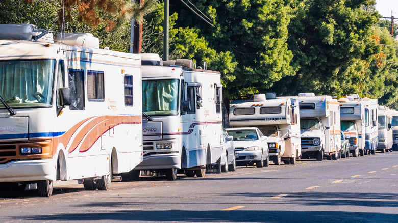 Several old RVs parked along a city street in the San Francisco area