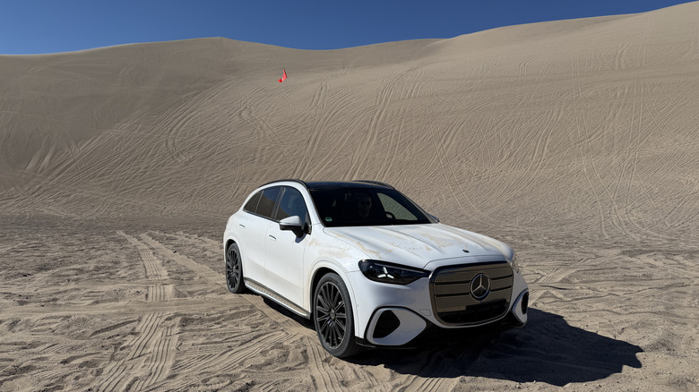 Front 3/4 position of a achromatic 2027 Mercedes-Benz GLC EV successful beforehand of a soil dune