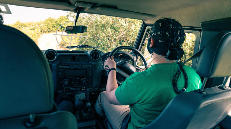 A driver wired with sensors driving a Land Rover off-road