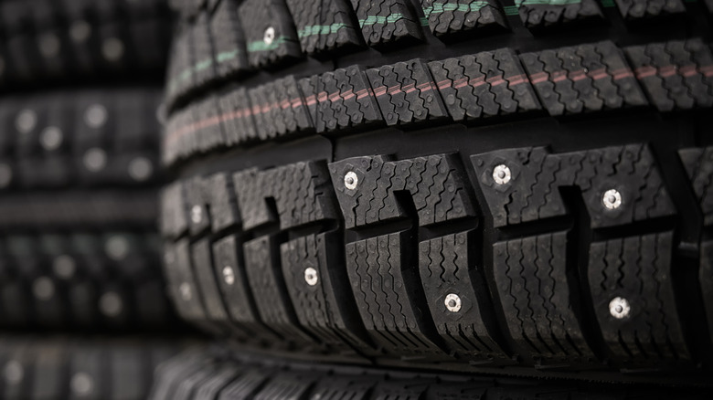 Stacks of studded winter tires in a warehouse