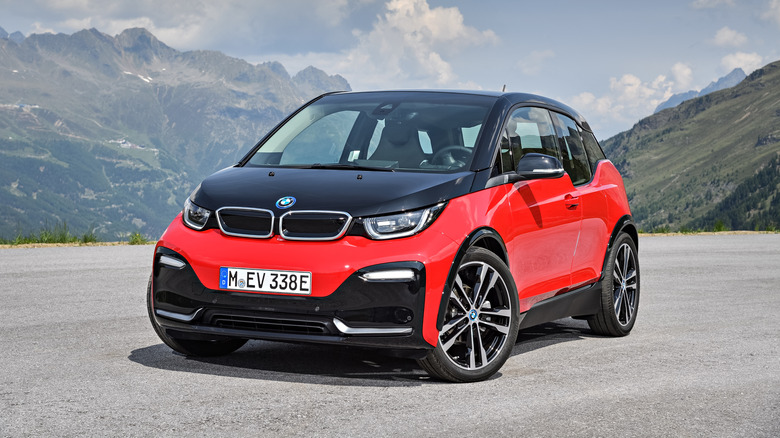 A red-and-black 2018 BMW i3s parked pinch upland successful nan background.