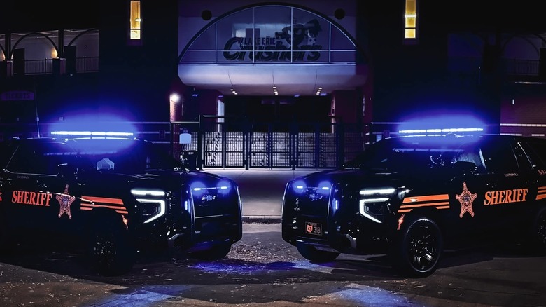 Two Lorain County Sheriff's Office cruisers parked outside at night