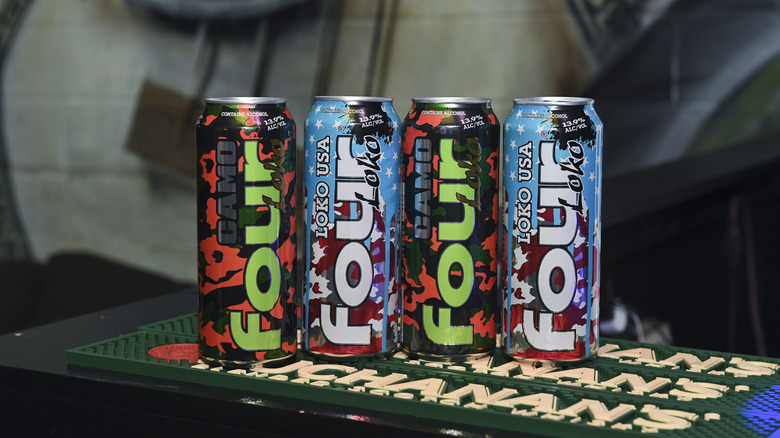 four Four Loko cans lined up on a bar