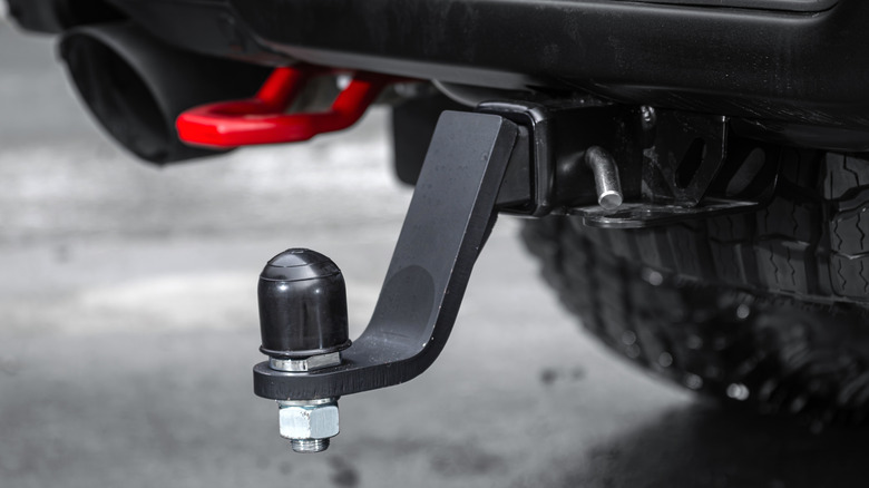A black pickup truck with a drop trailer hitch
