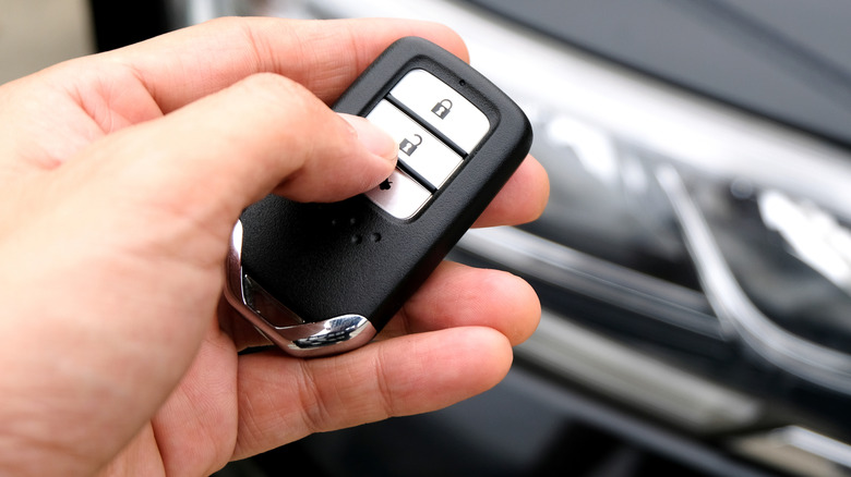 Man pushing car remote