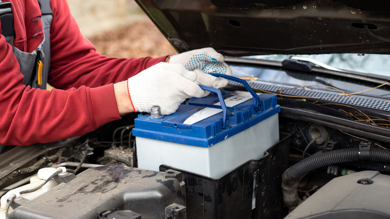 Mechanic replacing car battery