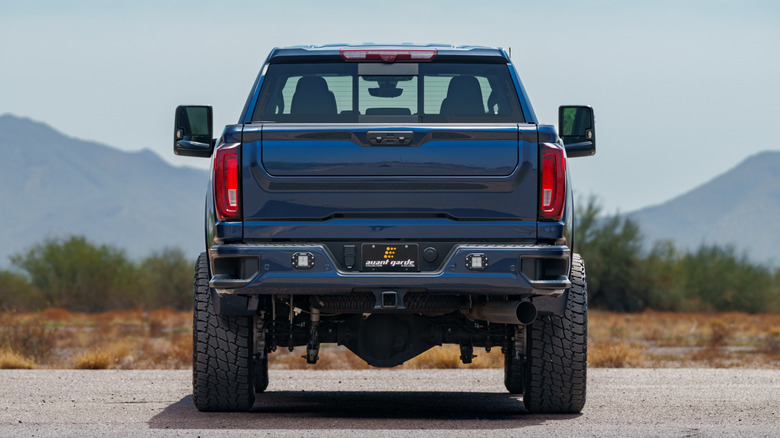 Tail section of a blue, lifted pickup truck