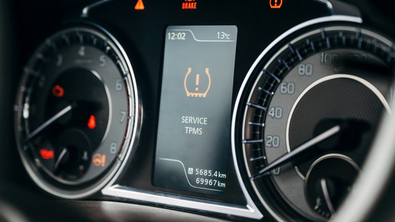 A car display showing a service TPMS warning